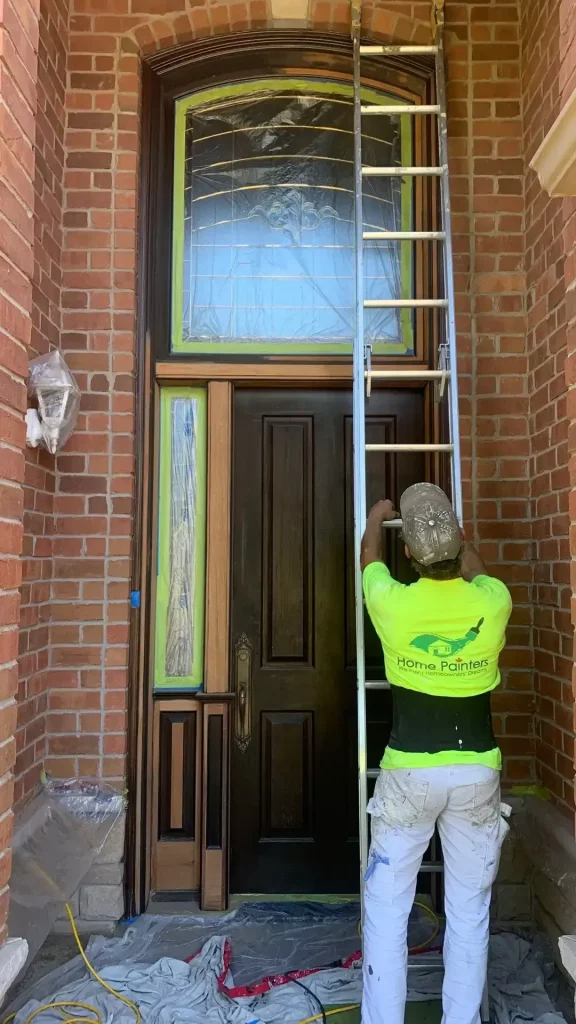 painter with ladder in front of door in Toronto