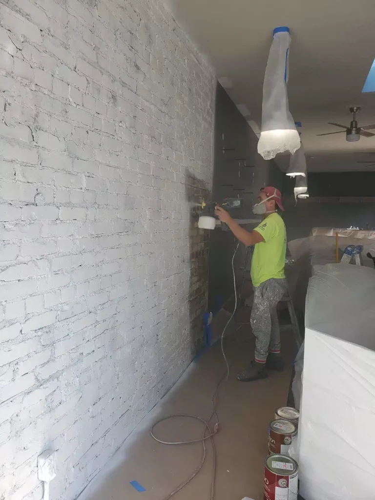 painter spraying wall