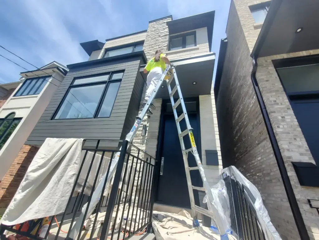 painter painting with high ladder