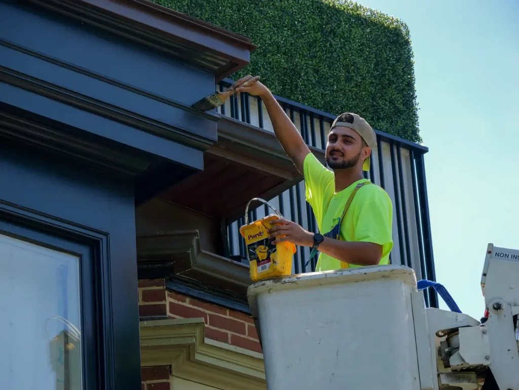 painter on a cherry picker while painting