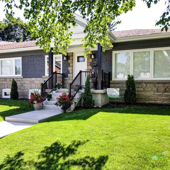house in toronto, ontario with charcoal grey painted brick exterior and wood window trim painted white to improve curb appeal local toronto home painters
