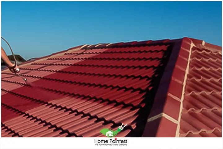 painter painting galvanized steel roofing panels