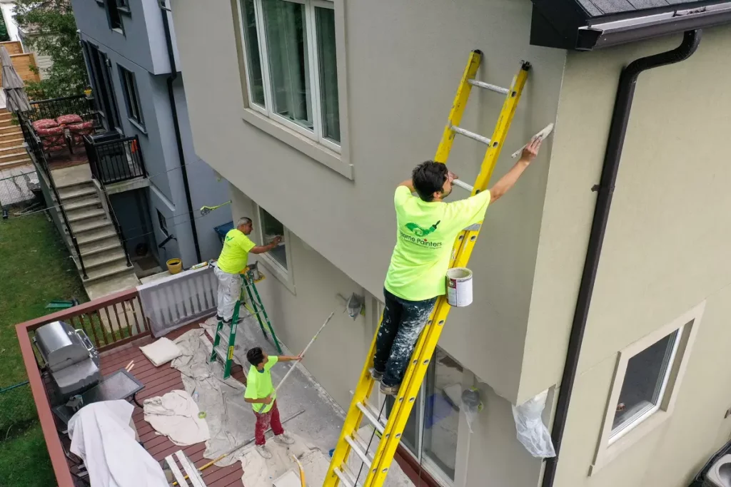 painters painting exterior with ladder
