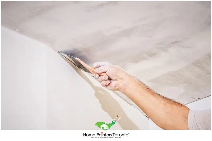 Painter Stripping Paint Off The Ceiling