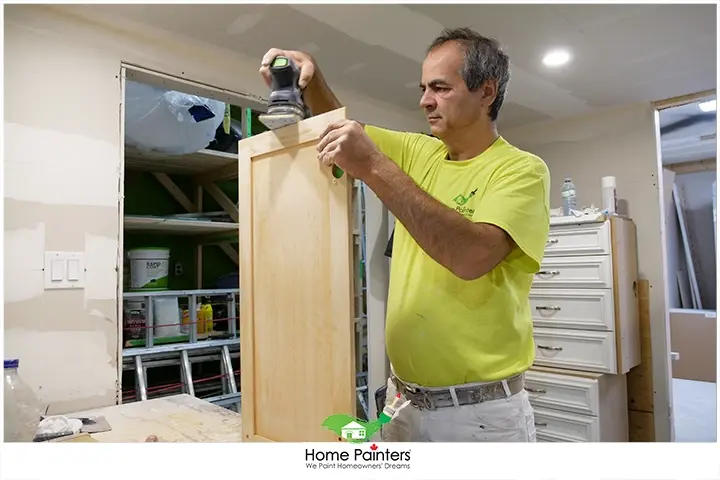 Painter Refinishing Oak Cabinet