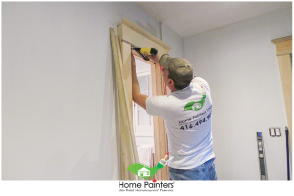 Carpenter fixing door frame at a room in mississauga
