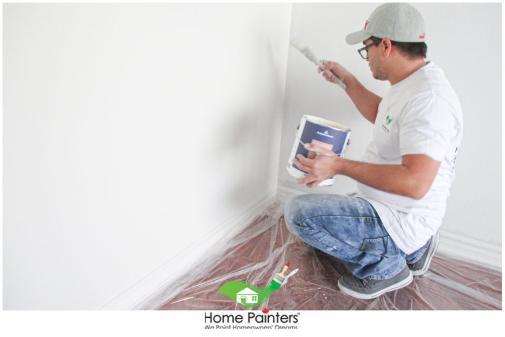 interior painters painting a white wall, professional painters, Toronto painters, painting companies, best paint for walls, house painting toronto, professional painters, house painters, home painting services, painting services, painting companies toronto