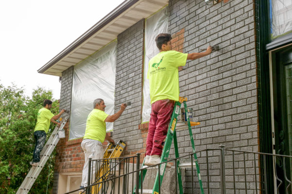 workers and painters_brick staining_charcoal_painters brick painting exterior of home on ladders
