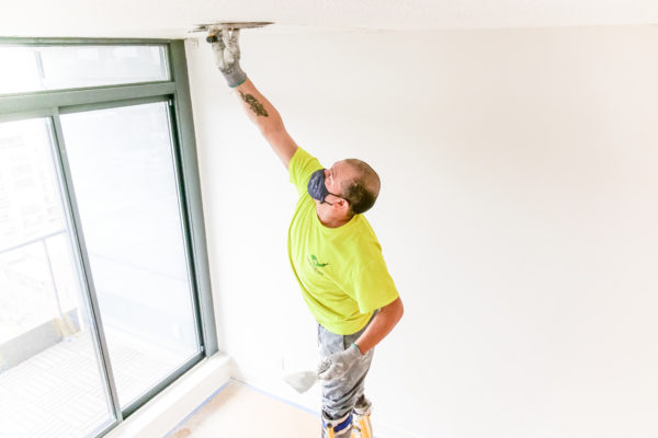 Professional house painters, Painter working on a popcorn ceiling removal in Toronto, house painters