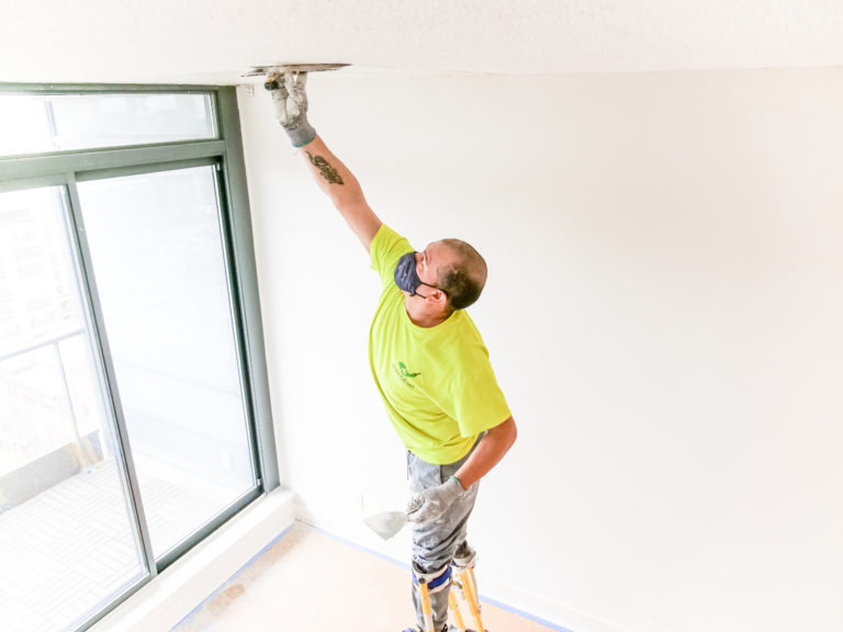 Professional house painters, Painter working on a popcorn ceiling removal in Toronto, house painters