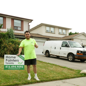 Professional home painter standing with confidence after painting exterior and interior and of house, exterior painting, interior painting