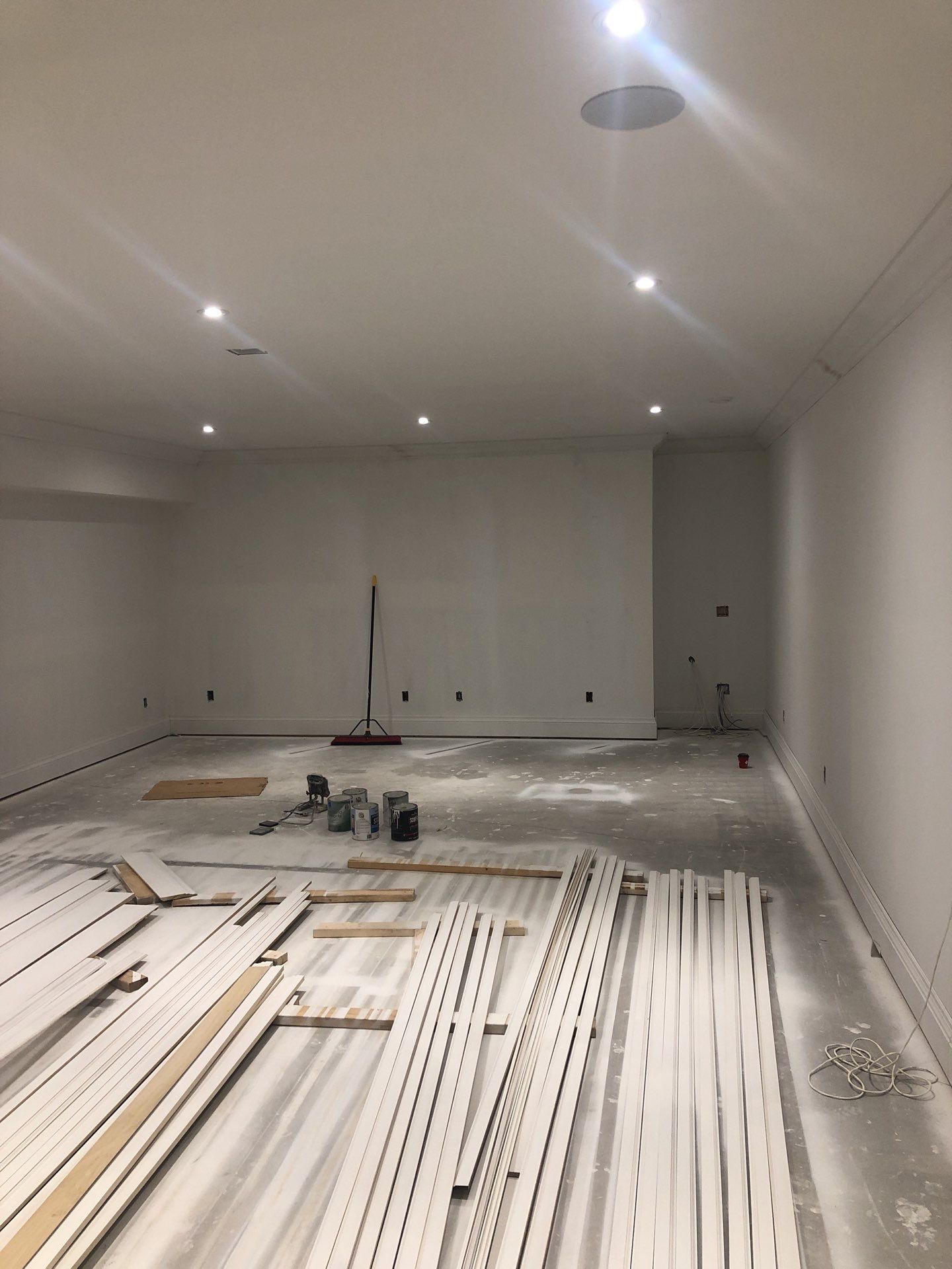 Interior Painting_Drywall Installation_White_uninished basement with trim on the floor