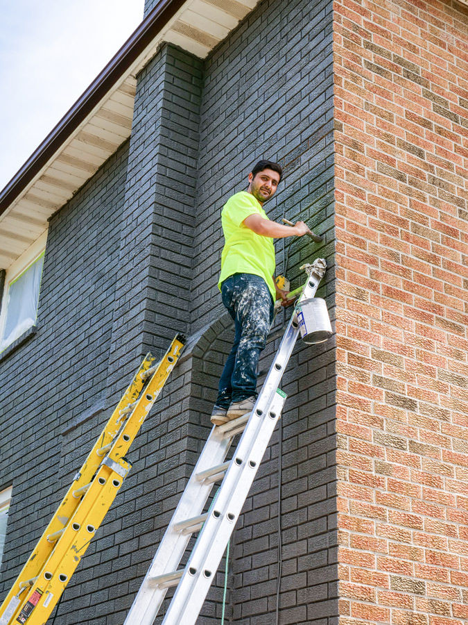 Exterior brick staining painters working on ladders home painters toronto