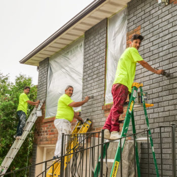 Exterior brick staining painters working on ladders home painters toronto