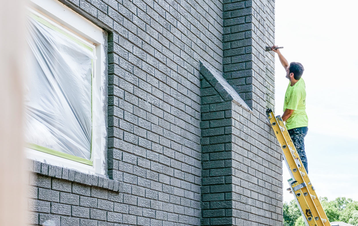 home painters working staining brick in canada