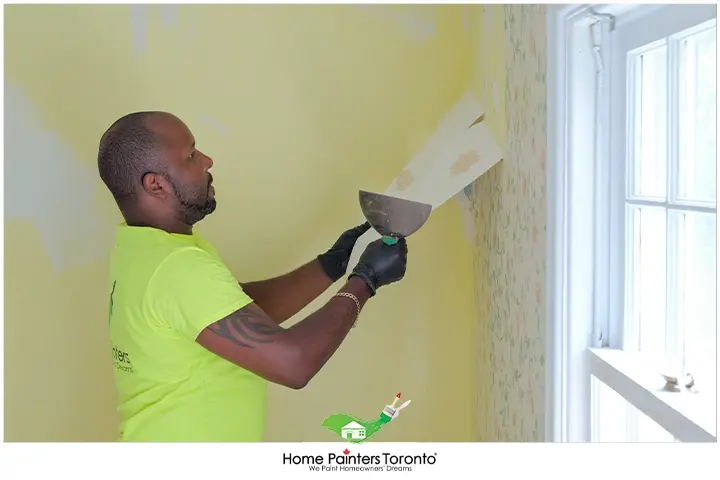 Painter Removing Wallpaper