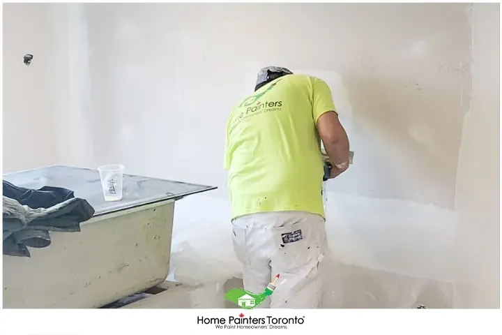 Painter Cleaning Drywall Dust