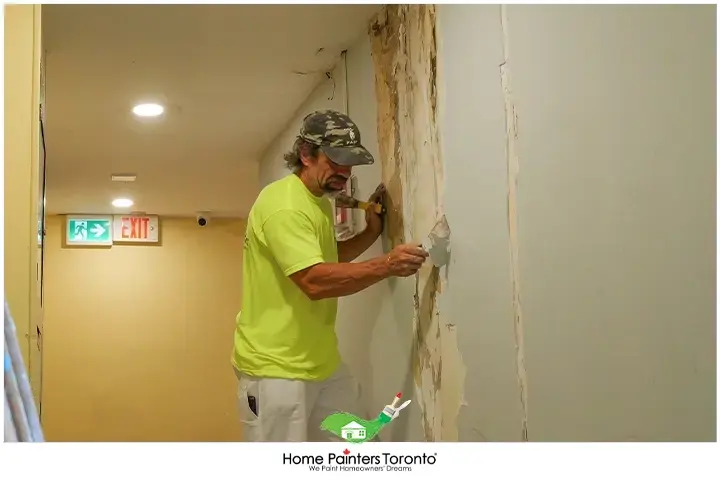 Painter Repairing Water Damaged Walls