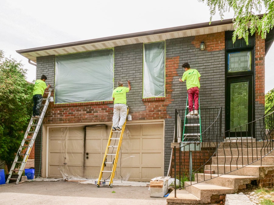 Exterior Brick Staining Painters Working on Ladders