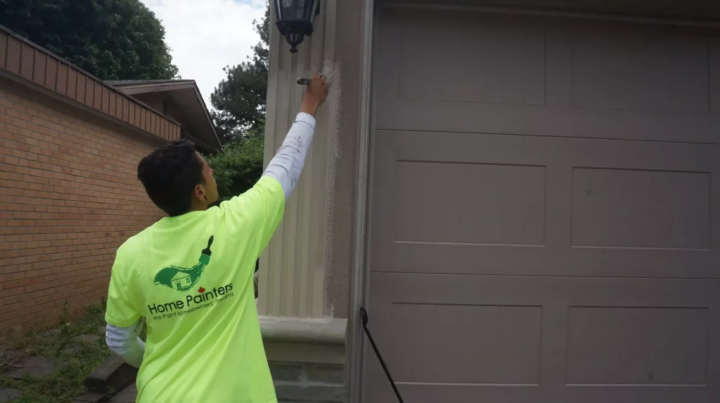 Painter painting garage door