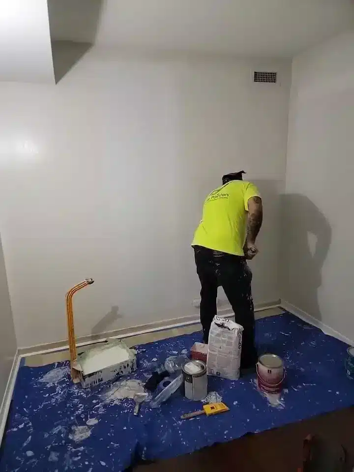 Painter Painting Wall Using Roller