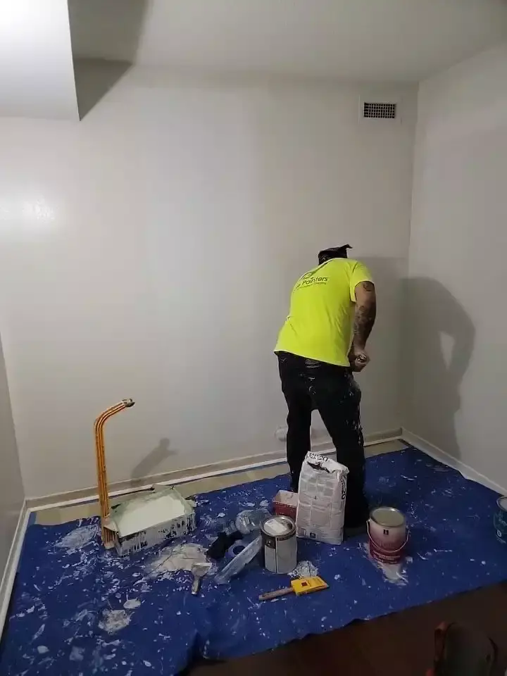painter painting with roller brush