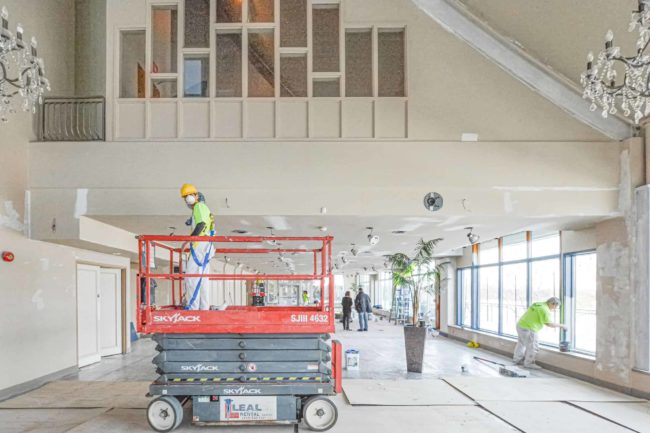 Commercial Painting Worker on Lift for Ceiling Painting