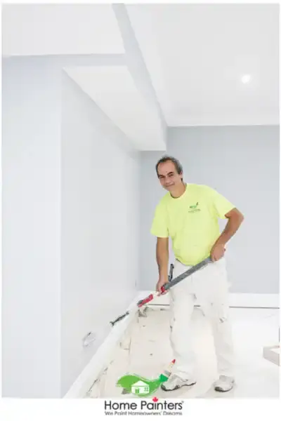 Interior Painting Home Blue Painter with roller by Home Painters Toronto