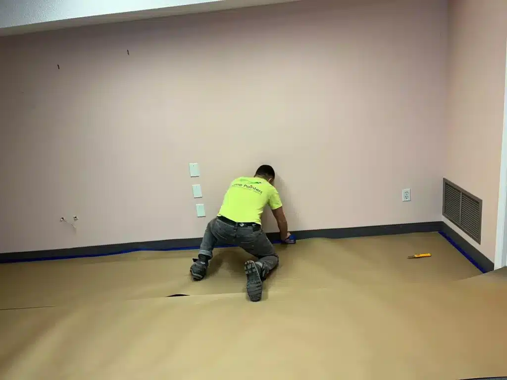 Painter Preparing the Room for Painting Using Tape