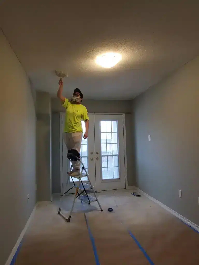 Painter Flattening the Stucco Ceilin