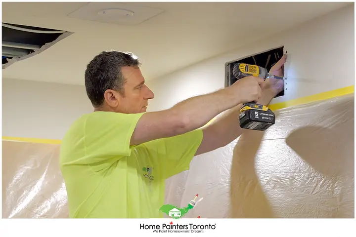 painter repairing drywall
