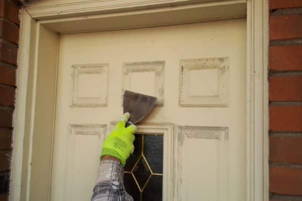 Painter prepping doors for painting