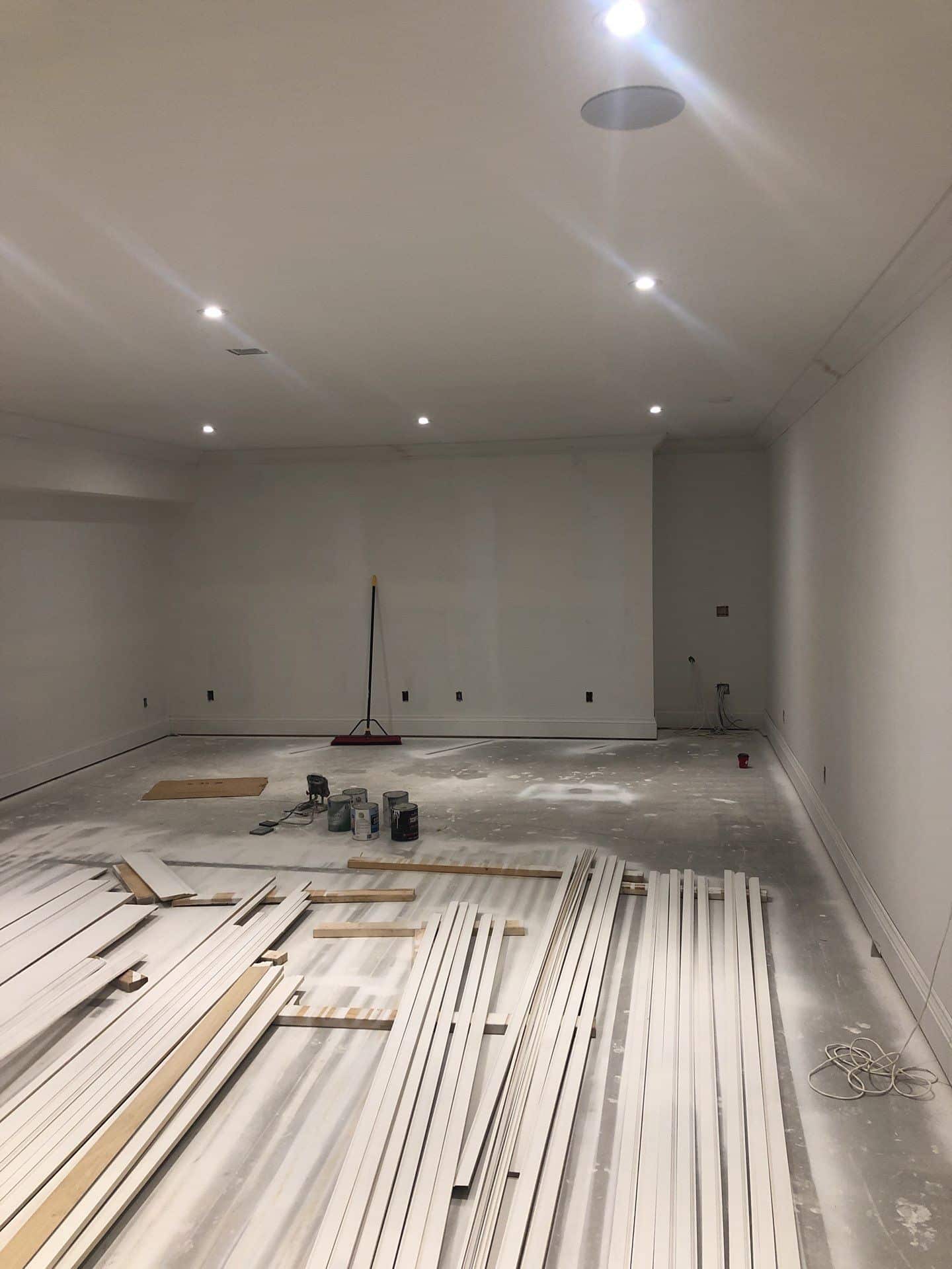 Interior Painting Drywall Installation_White_uninished-basement-with-trim-on-the-floor