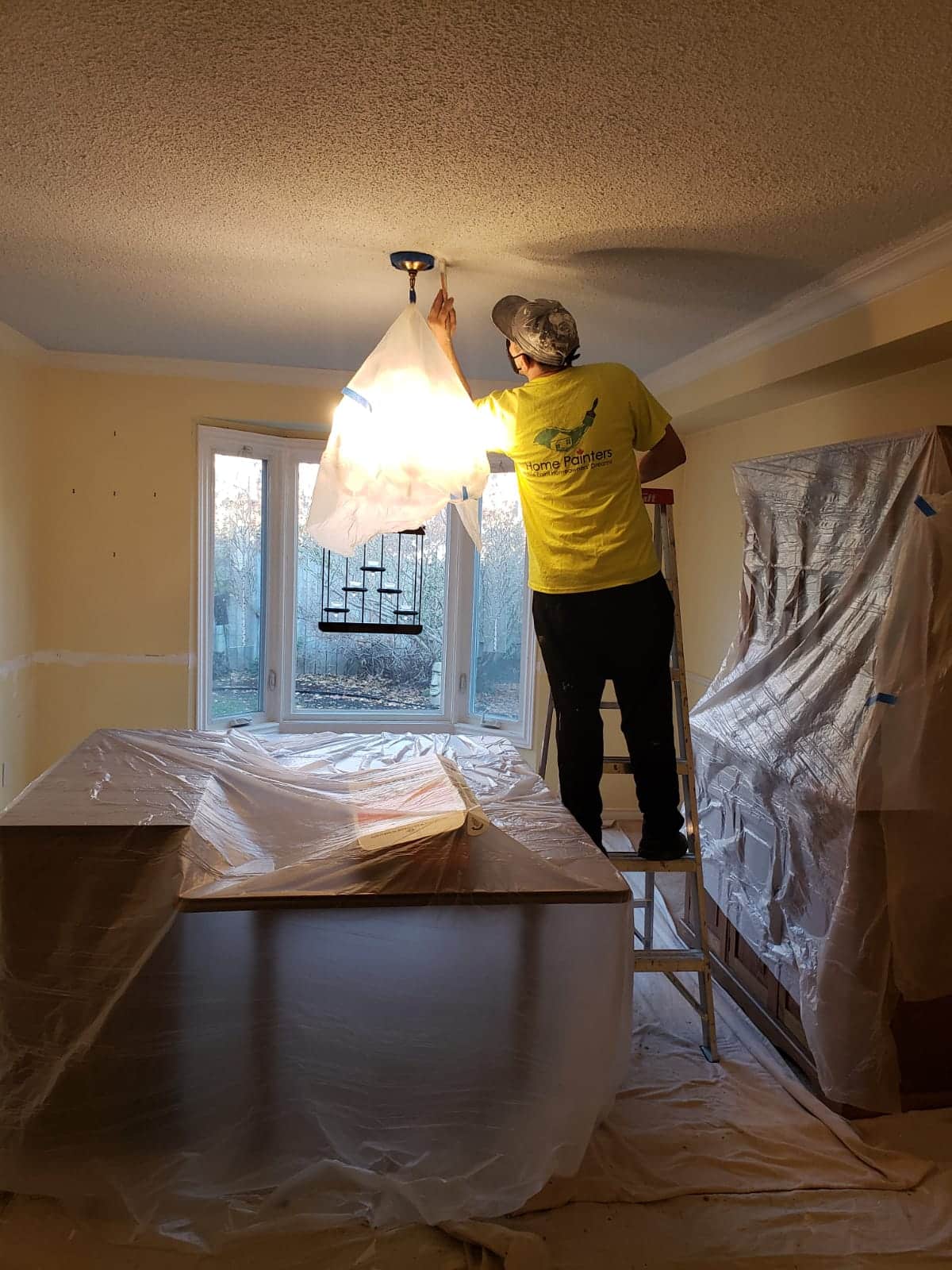 Painters putting drop sheets for protection