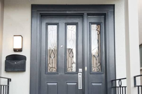 black front door on stone house