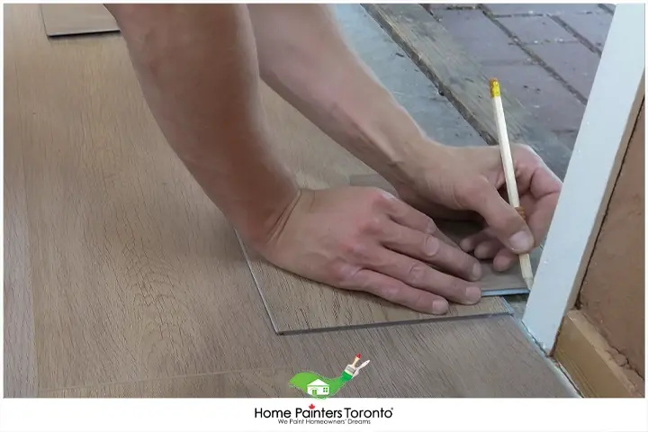 painter installing laminate flooring