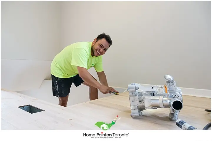 painter repairing laminate flooring