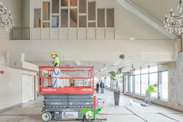 Commercial Painting Worker On Lift Painting Ceiling