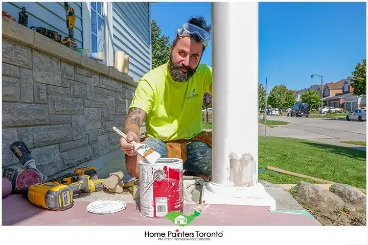 Painter Looking at a camera while working