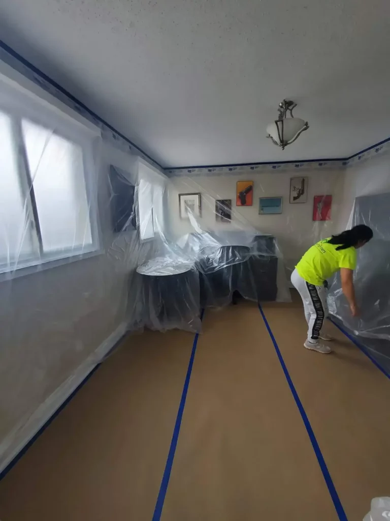 Painter Covering the Furniture