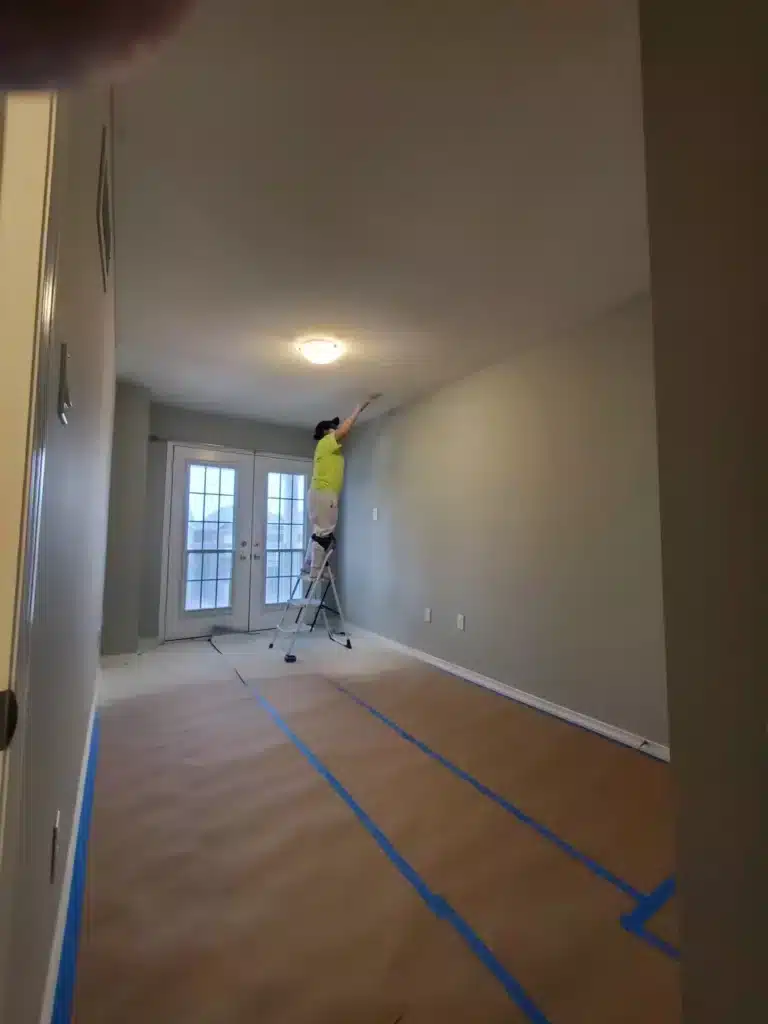 Painter Flattening The Stucco Ceiling