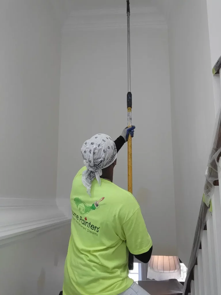 Painter Painting Ceiling with Roller Brush