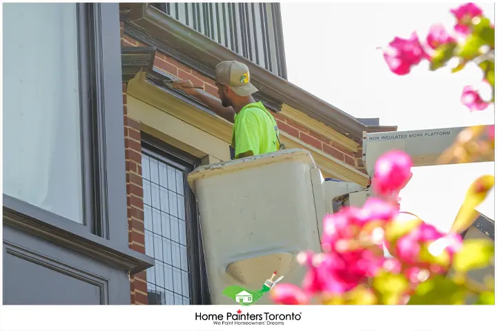 Painter Painting In Cherry Picker