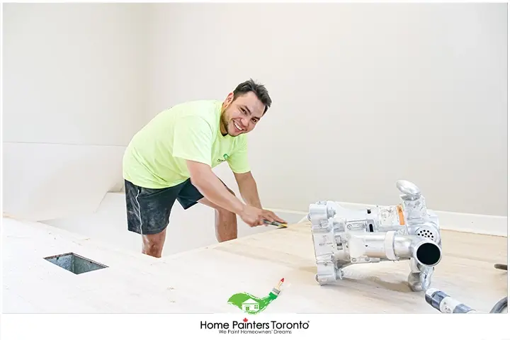 Painter Cleaning Hardwood Floors