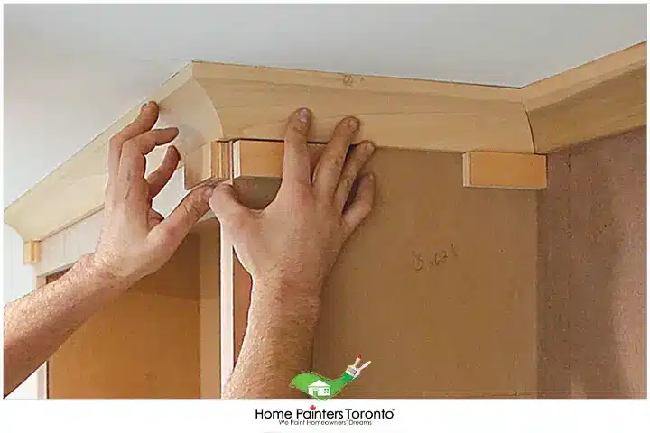 Painter Installing Crown Moulding