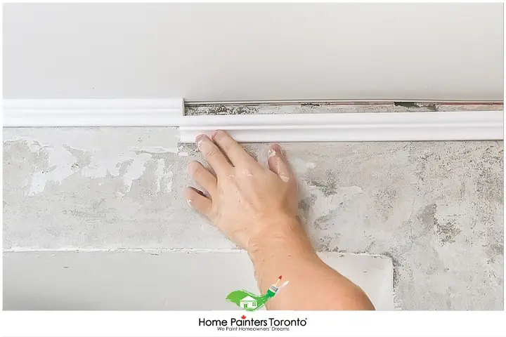 Painter Installing Shoe Moulding