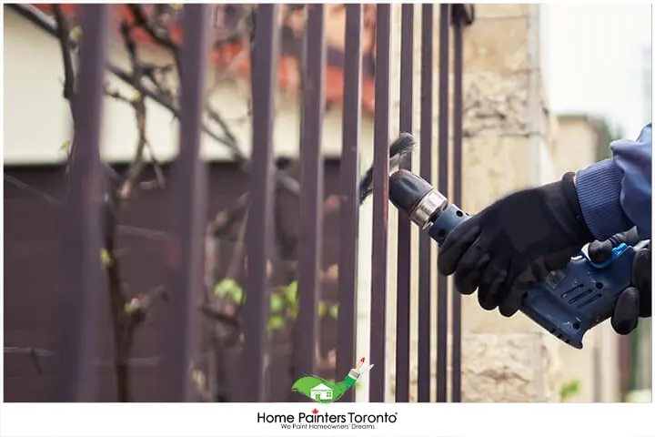 Painter Repairing Iron Fence