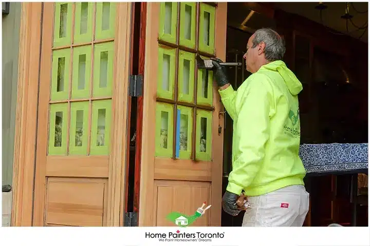 Painter Staining A Door