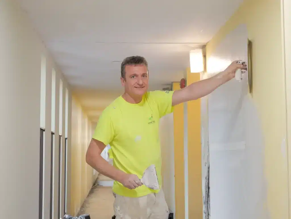 Painter Scraping Off Wallpaper