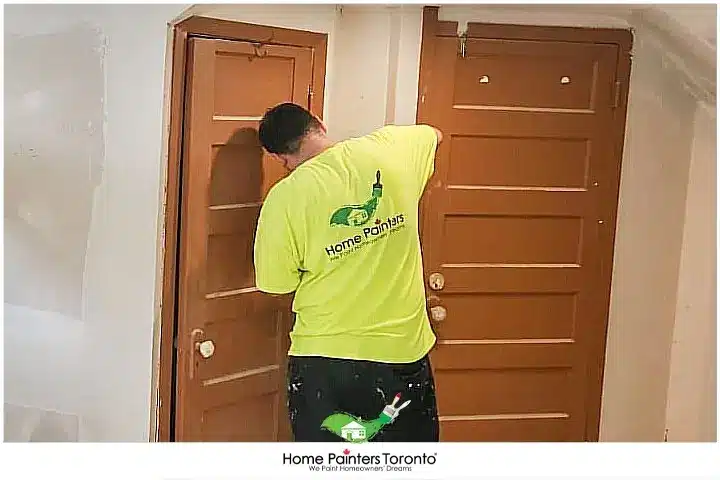 painter installing a door
